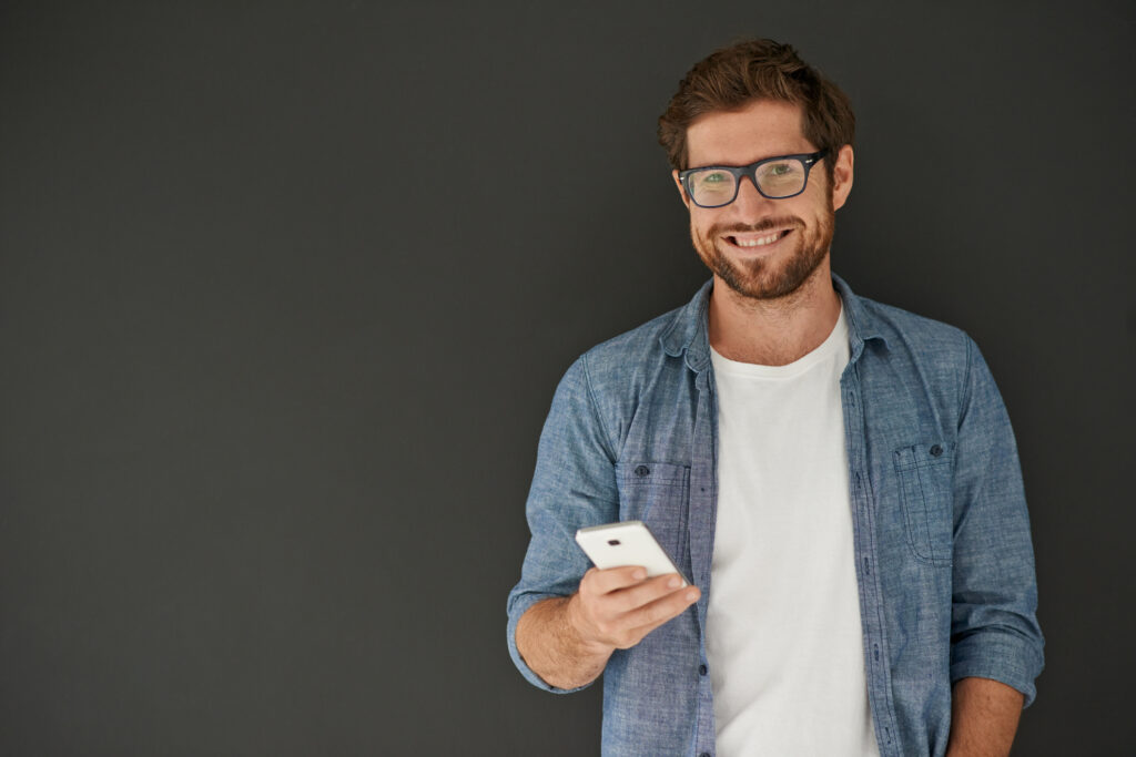 Man happily looking at phone using SalexLMS